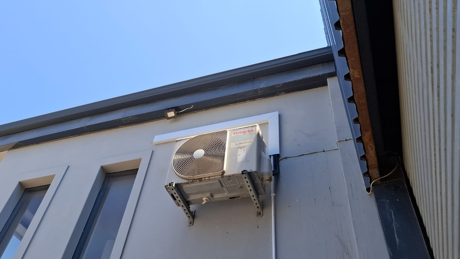 Toshiba inverter outdoor unit mounted on brackets high on a wall